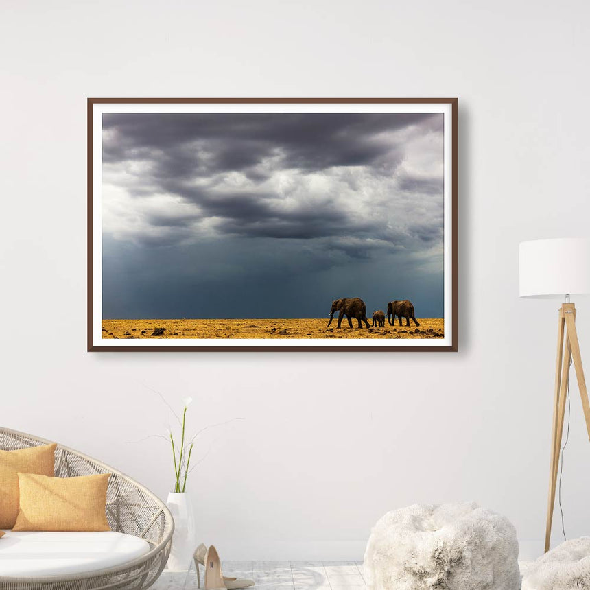 Fine art photographic print by Jonathan and Angela Scott, depicting elephants walking before the storm in Maasai Mara, Kenya.