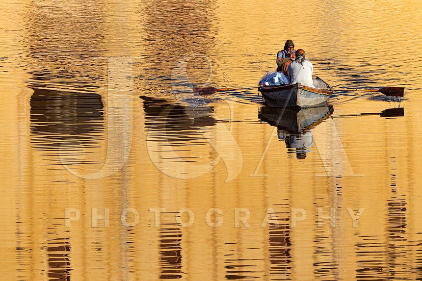 Fine art photographic print by Jonathan and Angela Scott, depicting a fisherman rowing at the Amber Fort in Jaipur, Rajasthan.