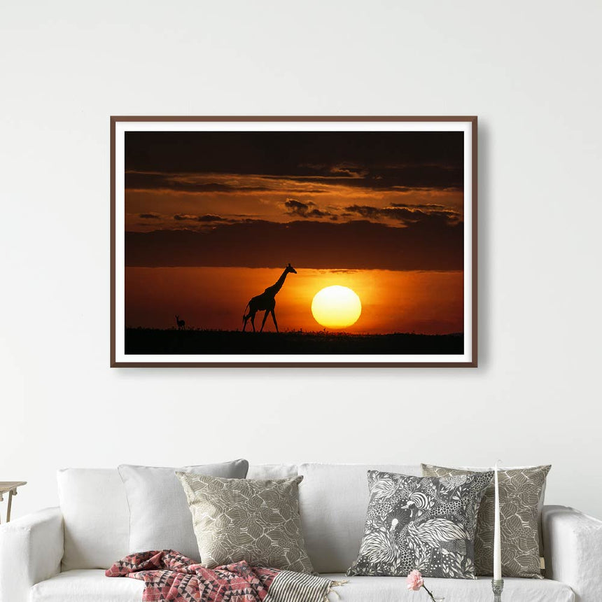 Fine art photographic print by Jonathan and Angela Scott, depicting a giraffe on the horizon at sunset in Maasai Mara, Kenya.